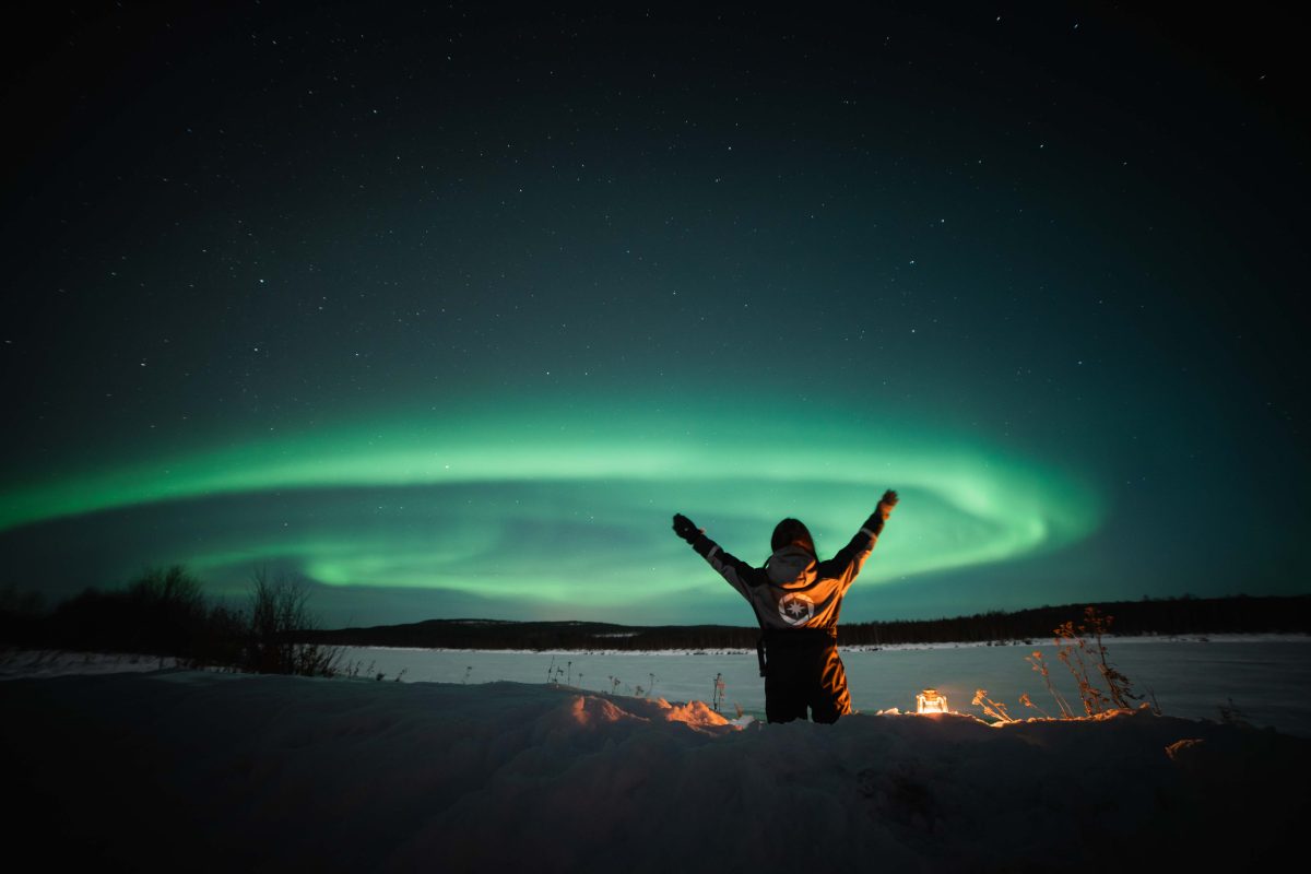 Northern Lights above a snowy riverside