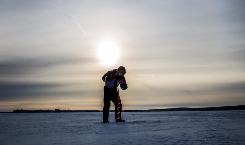Ice Fishing on a Frozen Lake in Levi