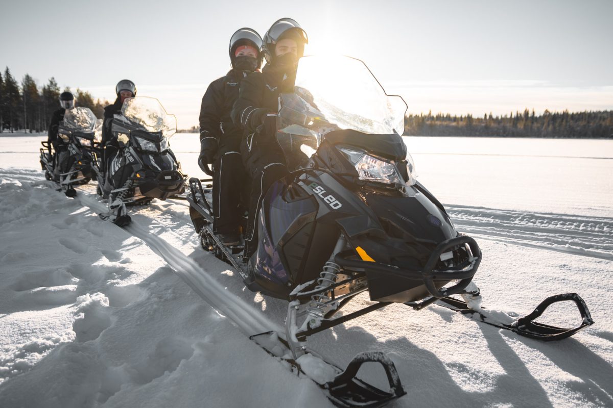 Guest riding an electric snowmobile in Rovaniemi