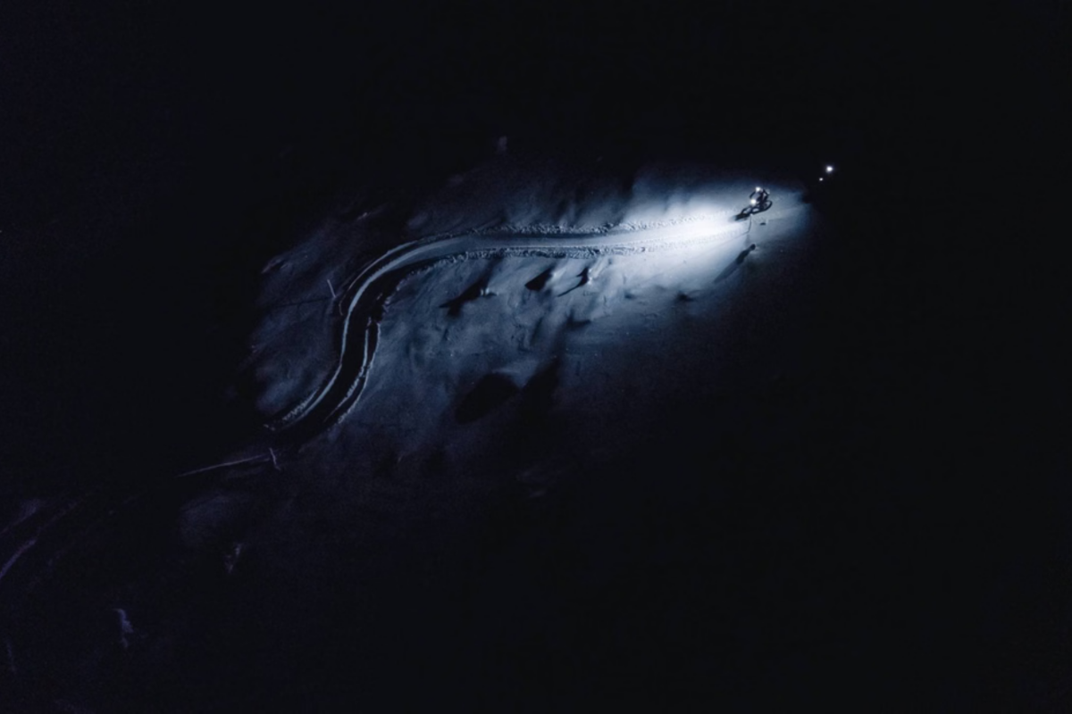 Electric fatbike rider on a dark snowy trail