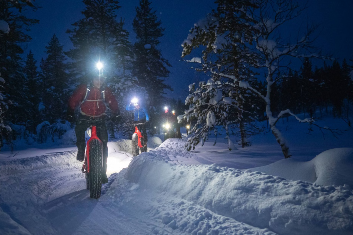 Night-time electric fatbike ride on a snowy trail