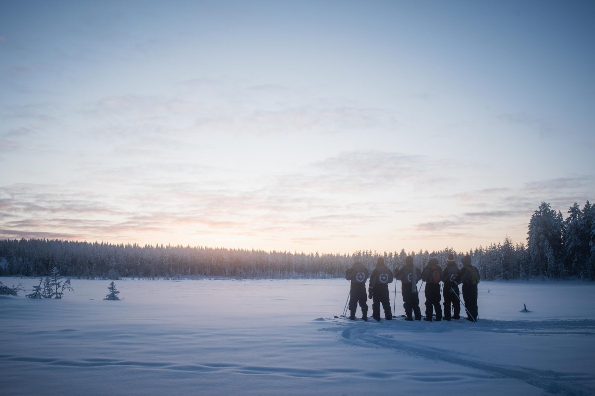Group in the snowy wilderness at sunrise