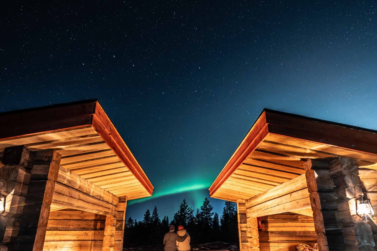 Campfire stop beneath the Northern Lights near Rovaniemi