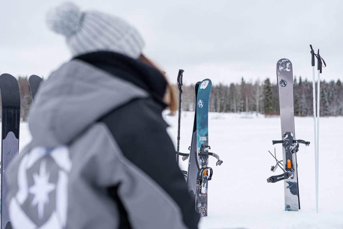 Ice fishers crossing a snowy landscape on skis