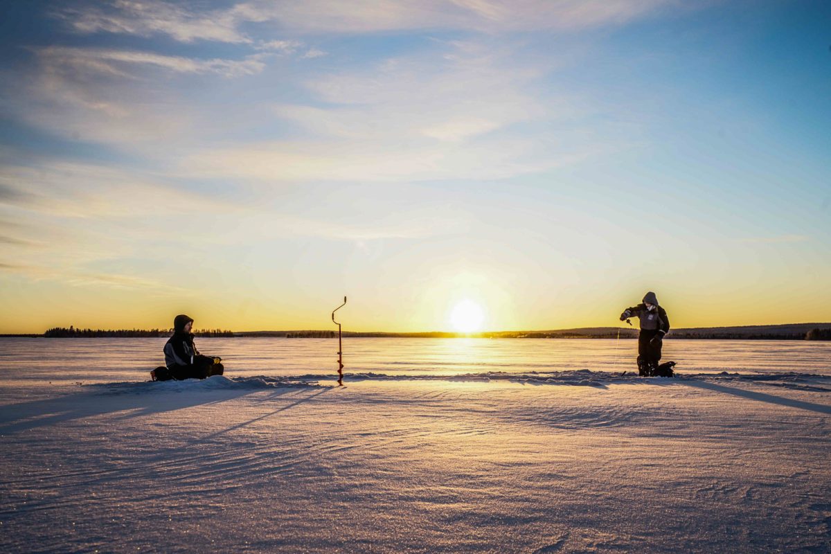 Ice fishing near Rovaniemi in clear weather