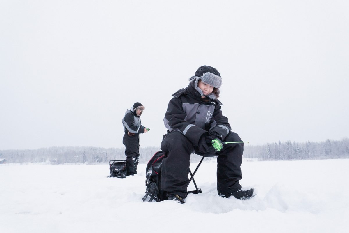 Ice fishing on a frozen lake near Rovaniemi