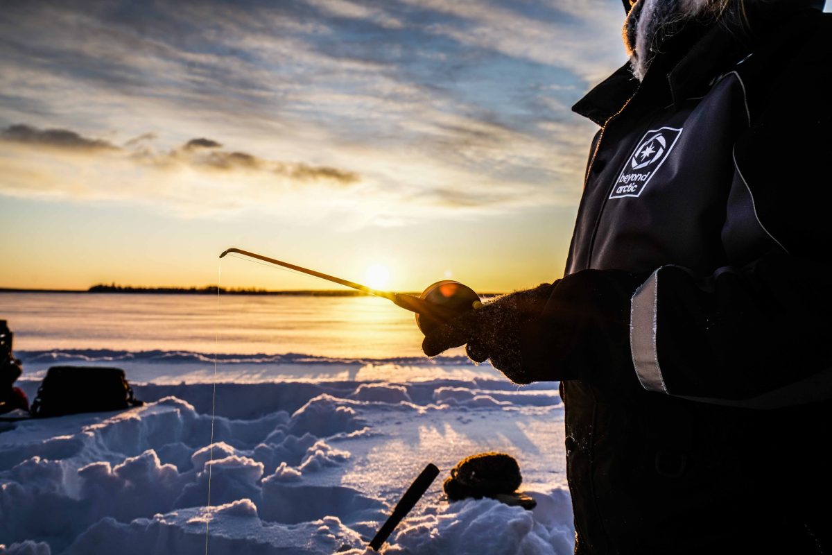 Frozen-lake ice fishing beneath the sun