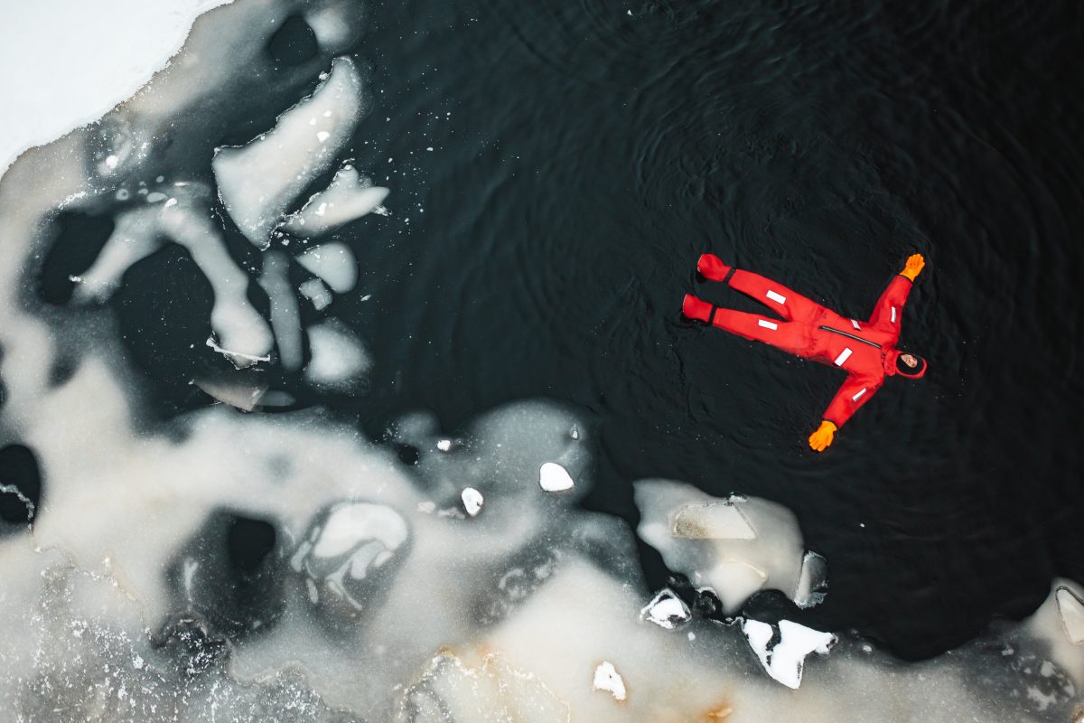 Guest floating in a frozen lake near Levi