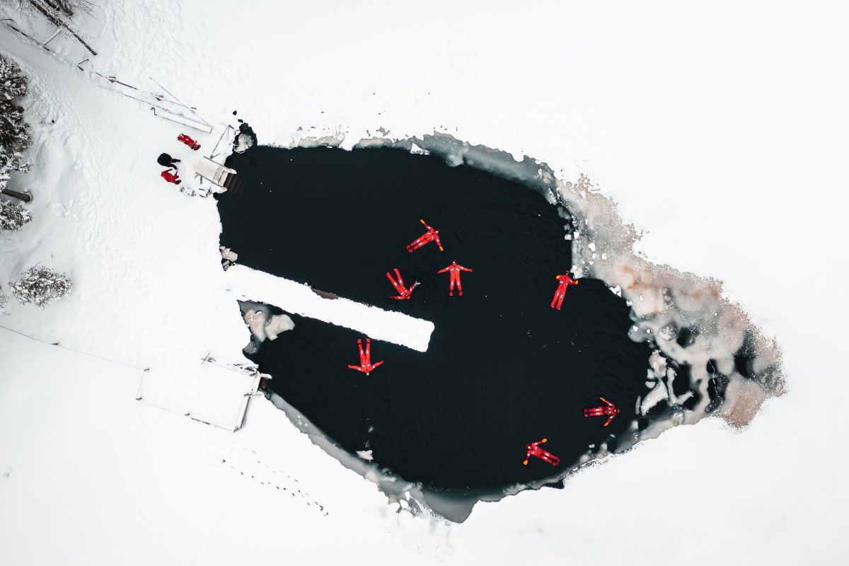 Group floating in a frozen lake near Levi