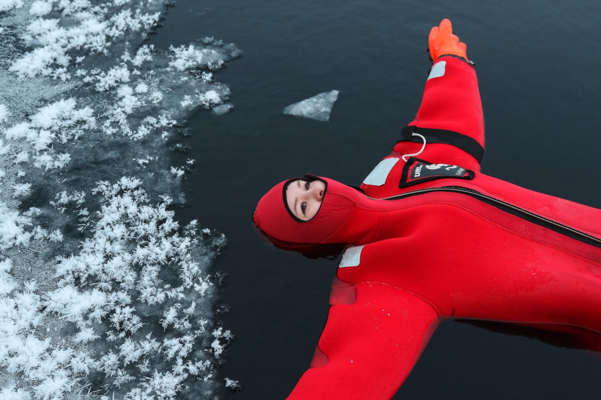 Guest looking up while floating in a rescue suit