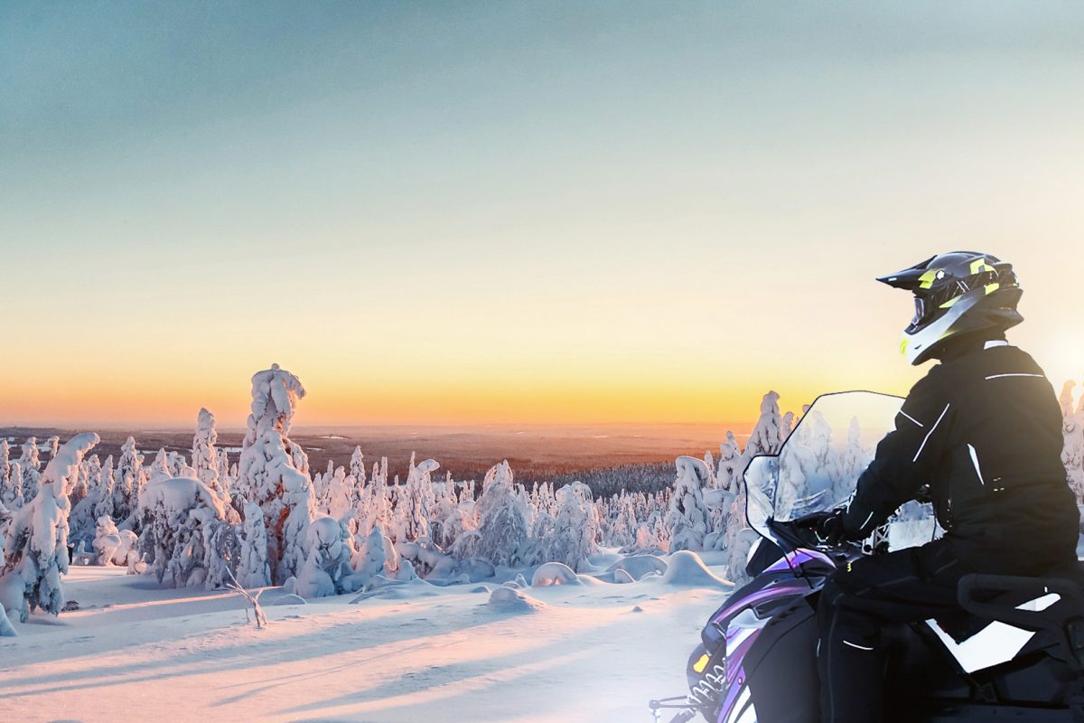 Snowmobile tour beneath the morning sunrise