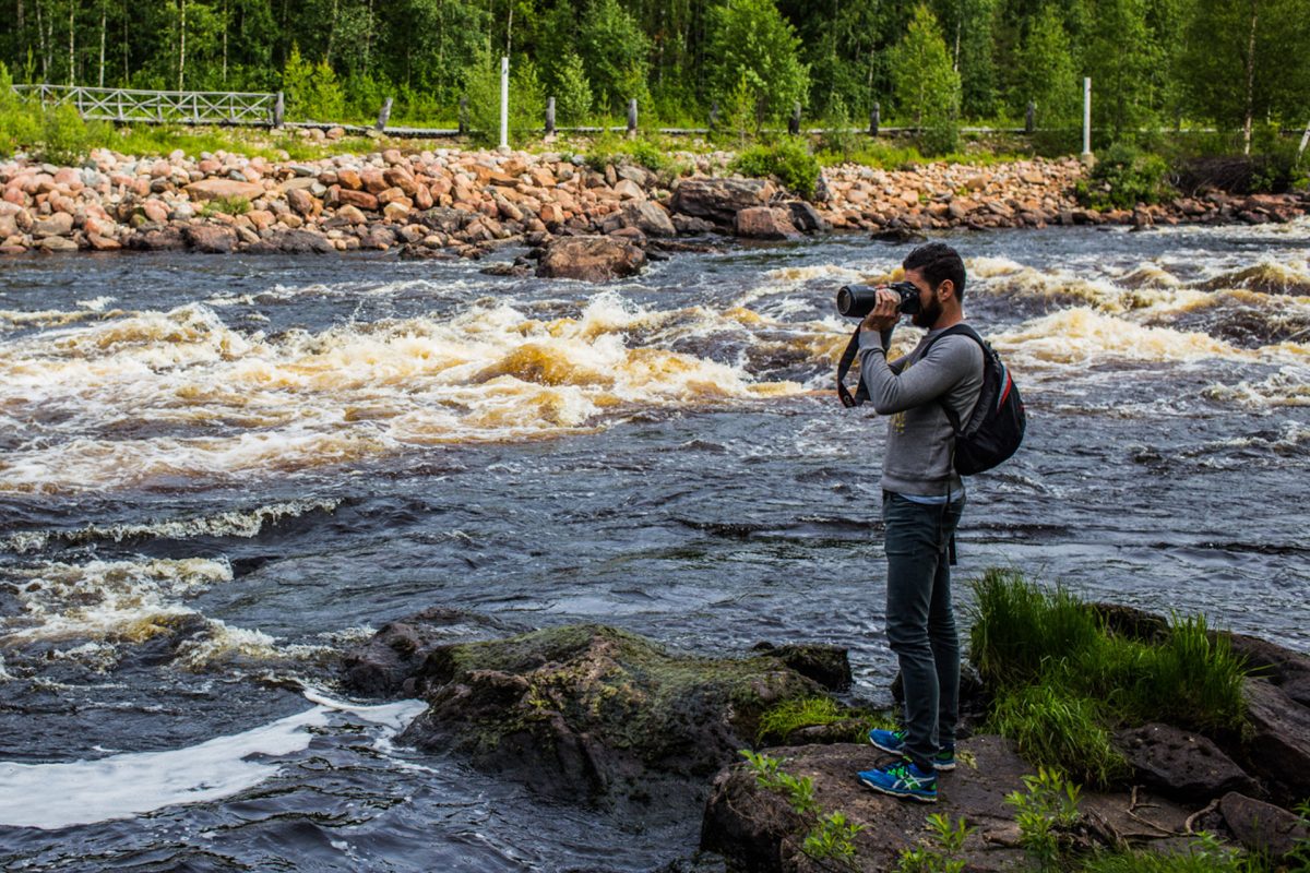 Photographer beside a wilderness river