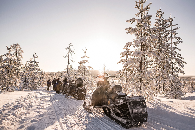 Snowmobile ride on a sunny winter day in Levi