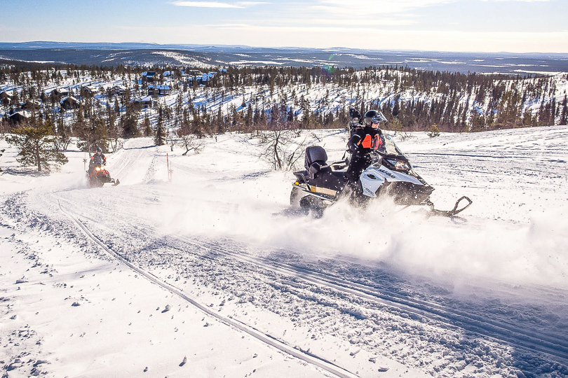Snowmobile adventure towards the fells near Levi