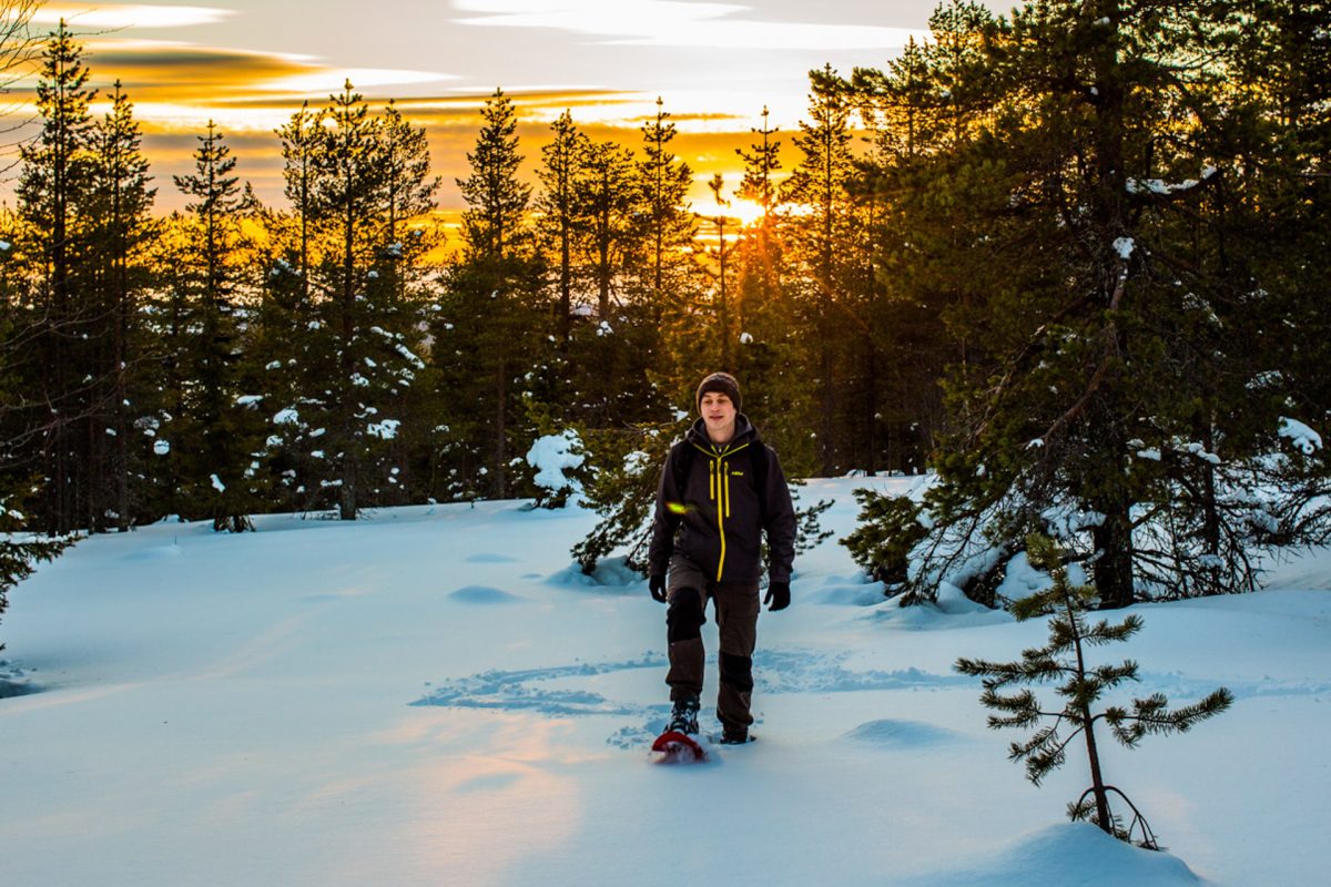 Snowshoeing uphill in Arctic nature