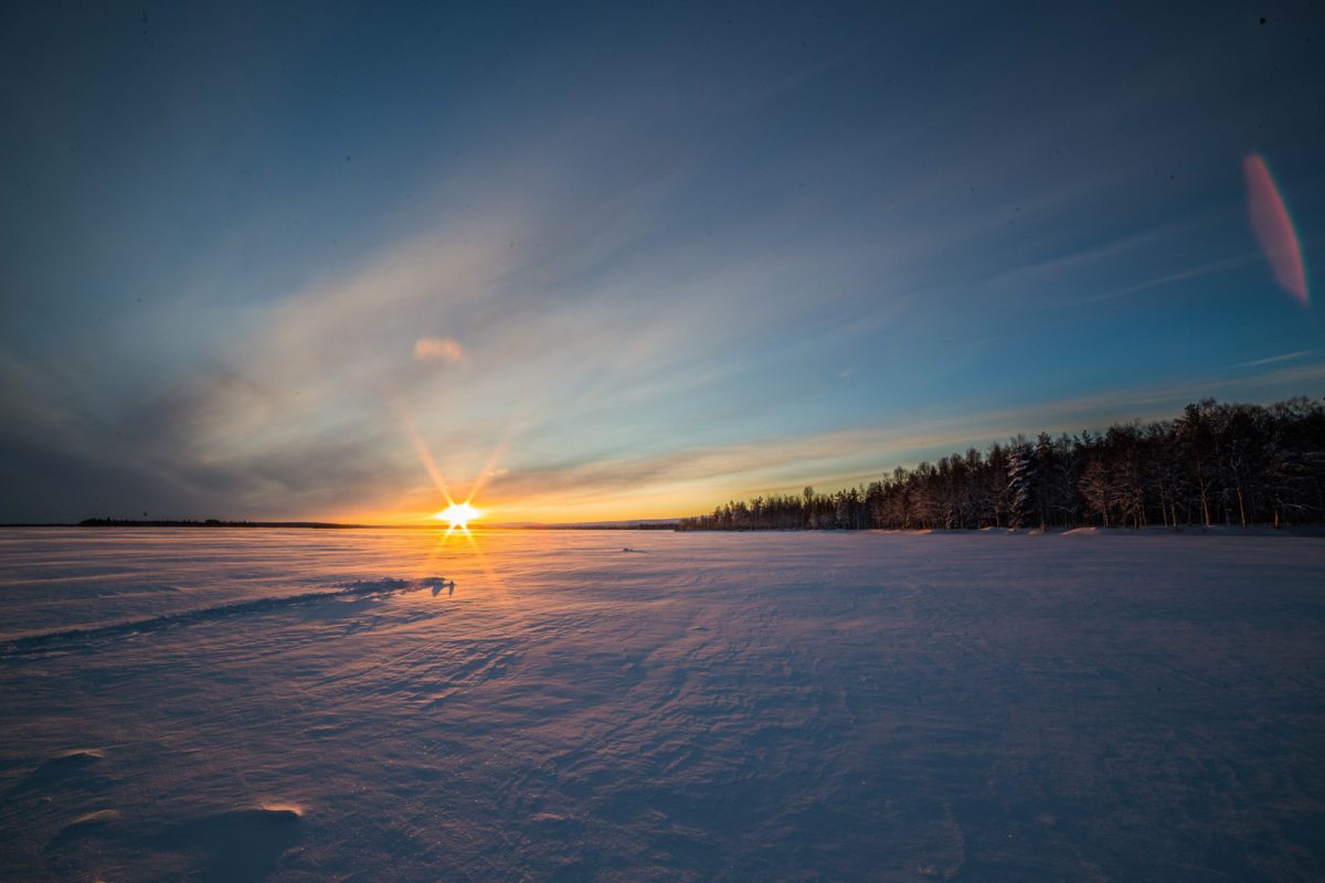 Winter light across a frozen lake near Levi