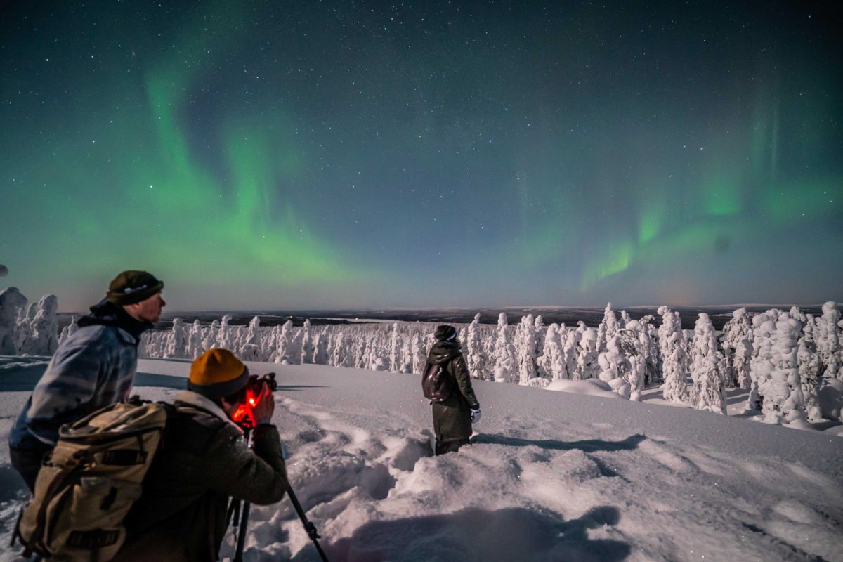 Photography group beneath the Aurora in Lapland